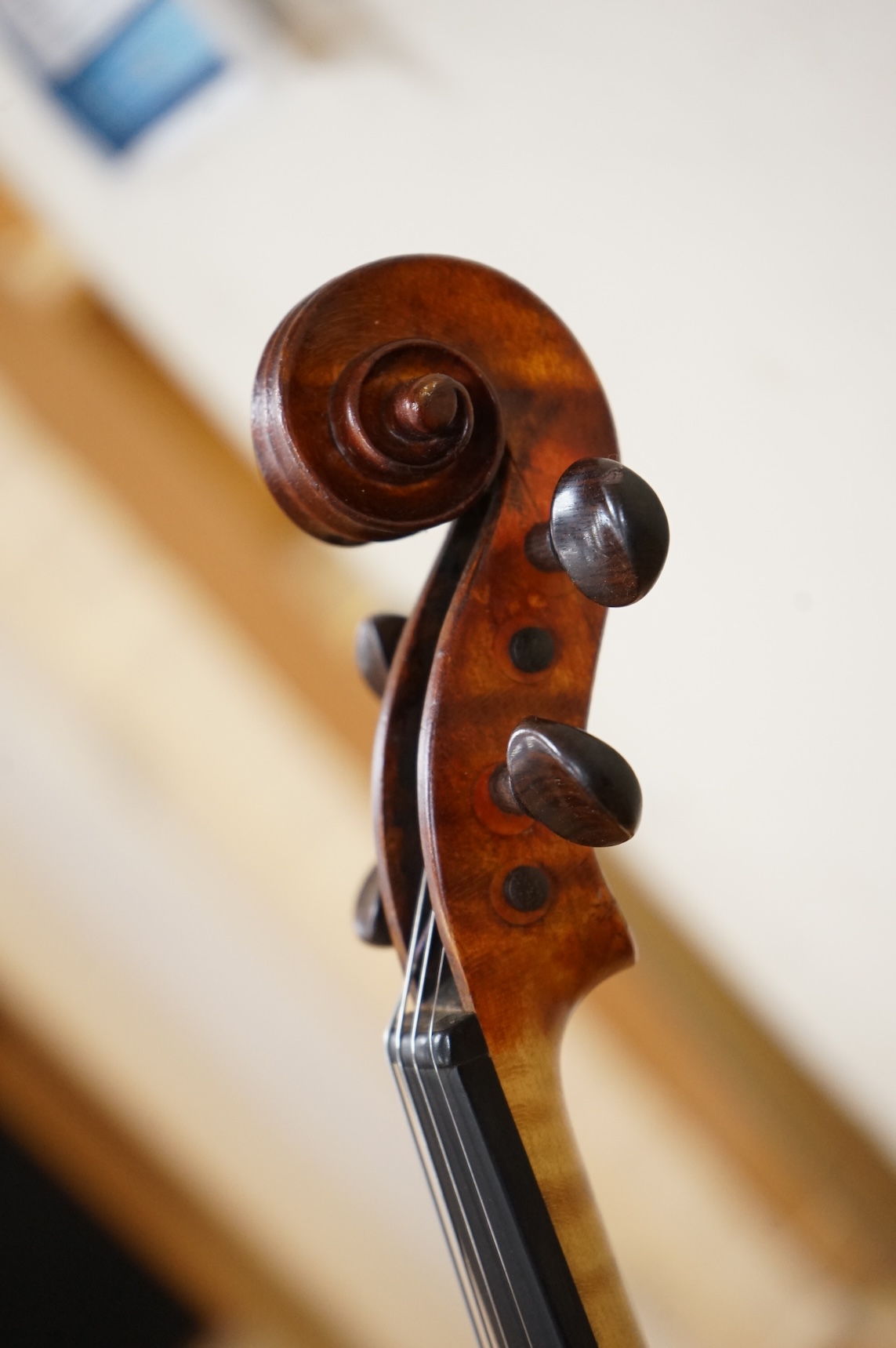 Three violins; a late 19th century German Stradivarius pattern violin, without label, a handmade violin (a.f.), with sound post crack, broken and repaired scroll, etc. and a Maidstone violin body, varnish stripped from t